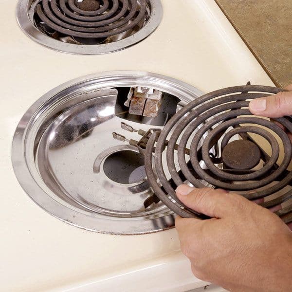 Lifting a coil burner element out of an electric range cooktop