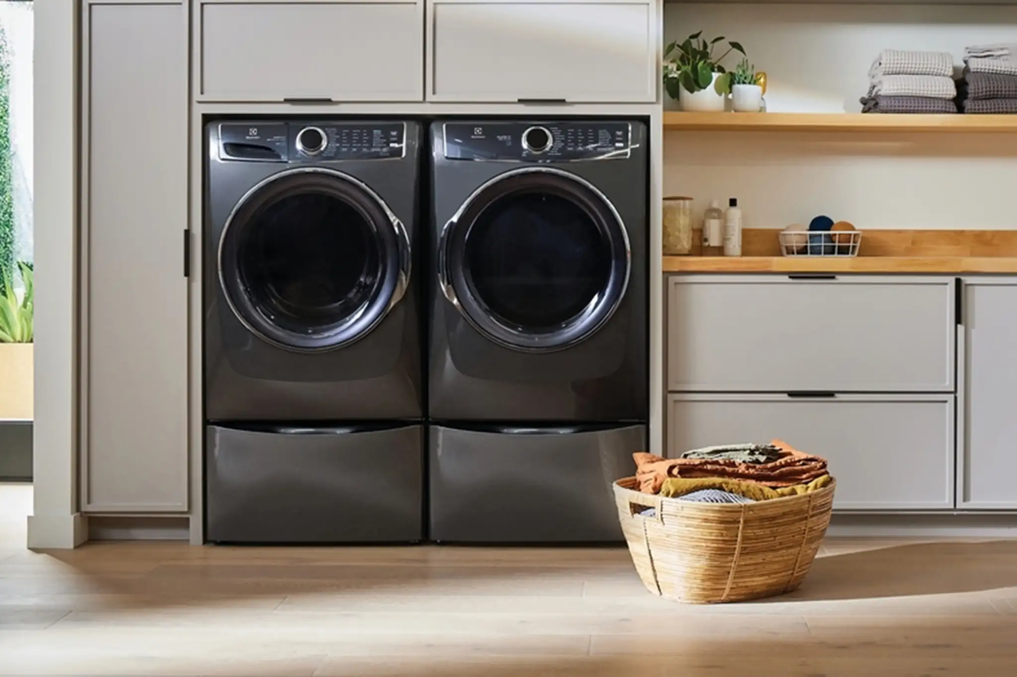 Front-load washer and dryer pair installed in a laundry room